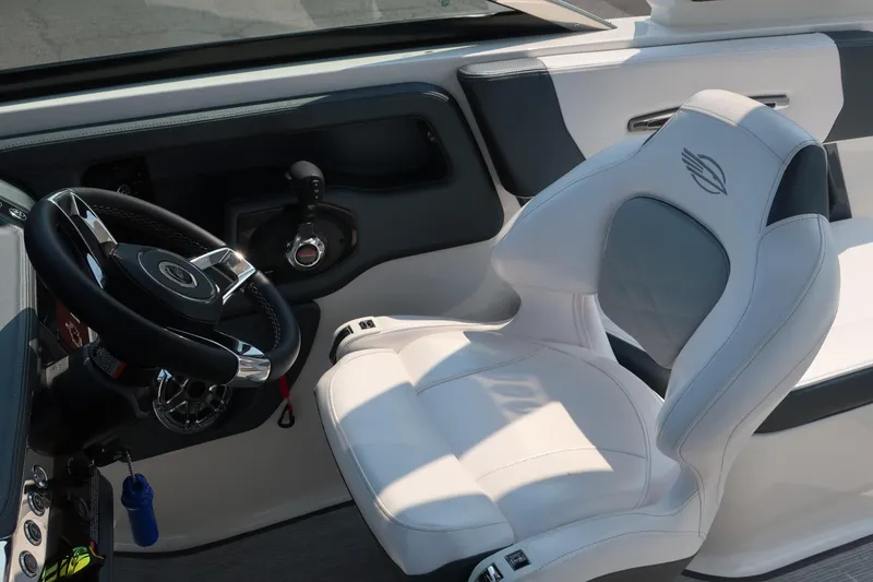 Slide: The Image of 2021 Chaparral 267 SSX boat interior with steering wheel and captain's seat. - 15