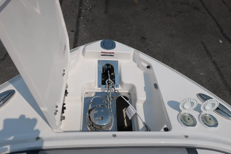 Slide: The Image of 2021 Chaparral 267 SSX boat anchor compartment with open hatch and chain mechanism. - 4