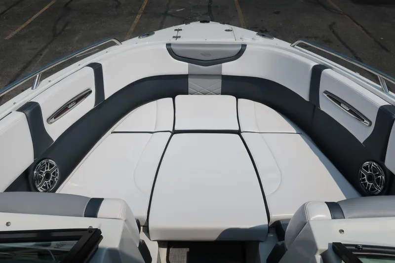 Slide: The Image of 2021 Chaparral 267 SSX boat interior with white and gray seating, speakers, and sleek design. - 5