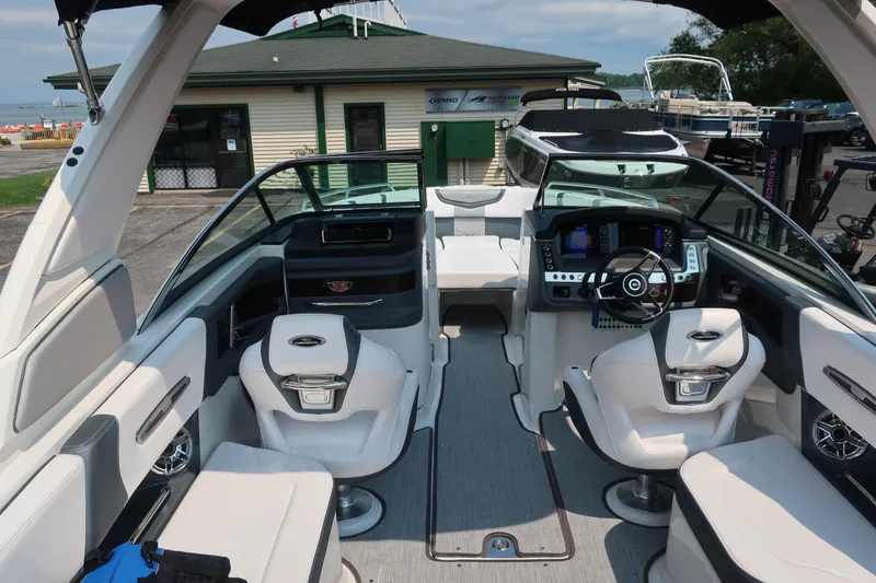 Slide: The Image of 2021 Chaparral 267 SSX boat interior with modern dashboard and seating. - 7