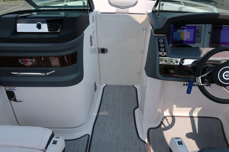 Slide: The Image of 2021 Chaparral 267 SSX boat cockpit with modern dashboard and steering wheel. - 8