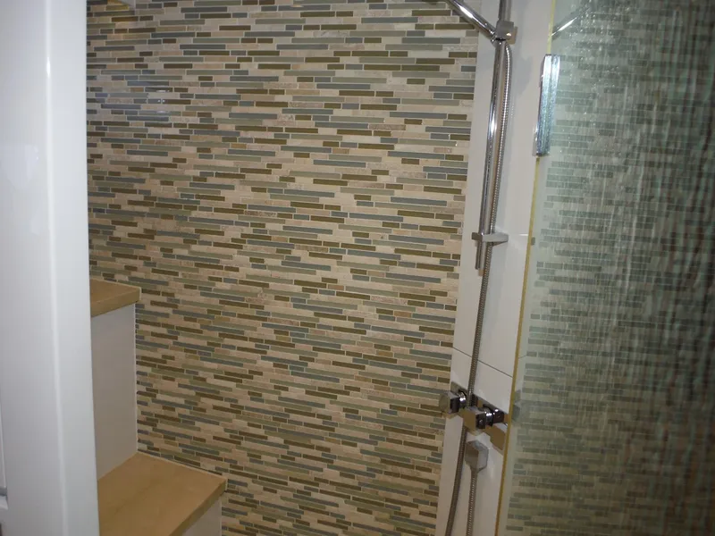 Slide: The Image of Luxurious bathroom in 2015 Horizon E88 yacht with modern shower and wooden cabinetry. - 41