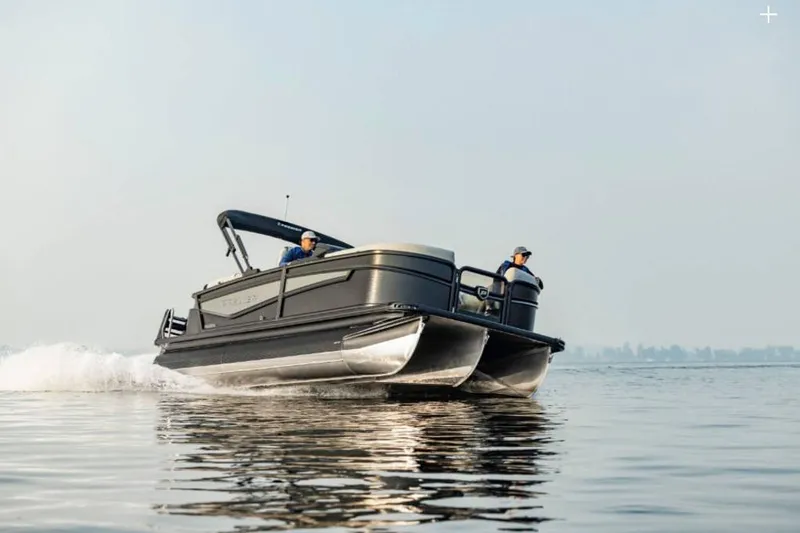 The Image of 2026 Premier 230 Intrigue RF pontoon boat cruising on calm water. - 1
