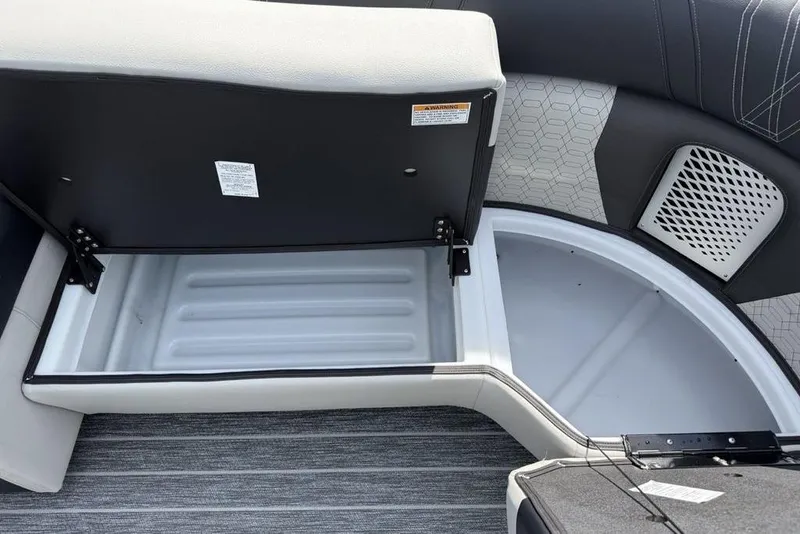 Slide: The Image of Open storage compartment in 2026 Premier 230 Intrigue RF boat with cushioned seating. - 10