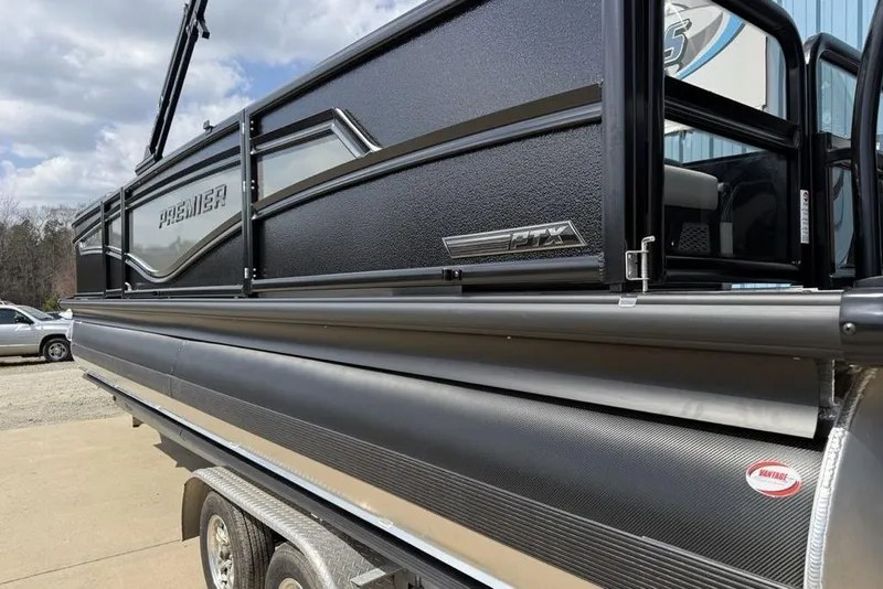 Slide: The Image of 2026 Premier 230 Intrigue RF pontoon boat, black exterior, parked on a trailer. - 11