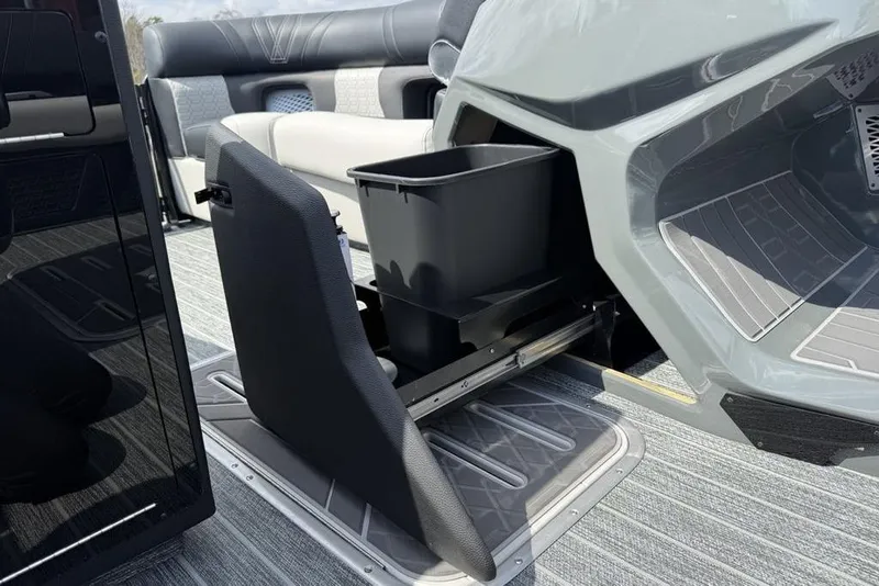 Slide: The Image of 2026 Premier 230 Intrigue RF boat interior with storage compartment and seating. - 13