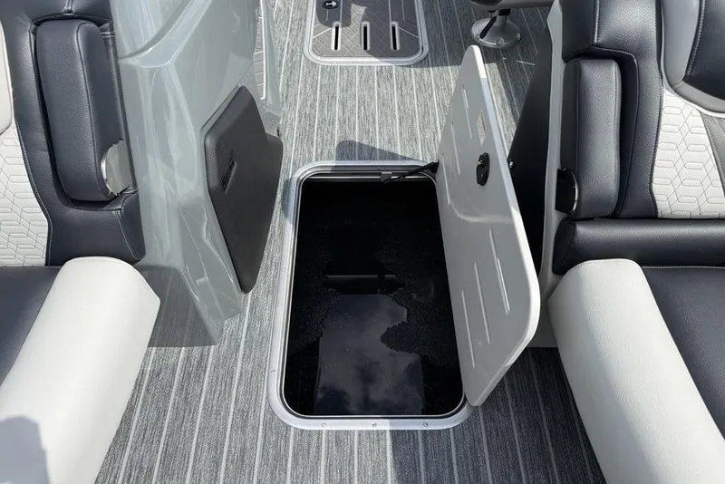 Slide: The Image of Open storage compartment on 2026 Premier 230 Intrigue RF boat with sleek seating. - 17