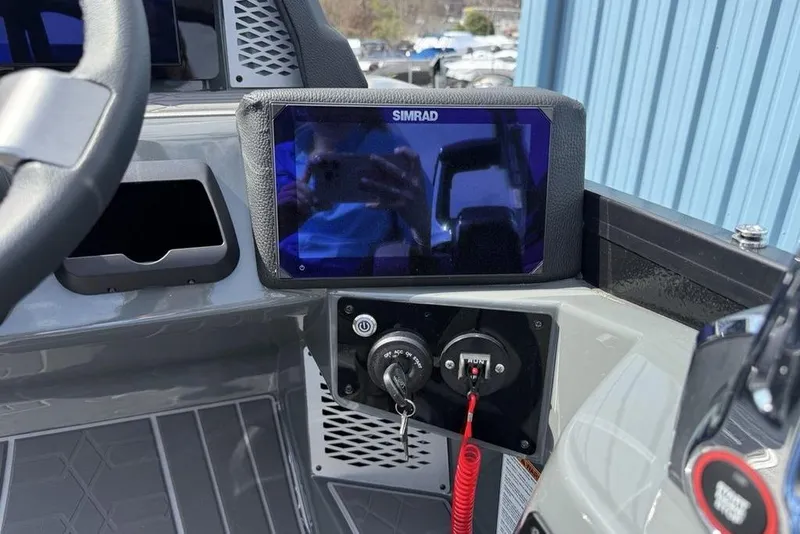 Slide: The Image of Dashboard of 2026 Premier 230 Intrigue RF with Simrad display and controls. - 19
