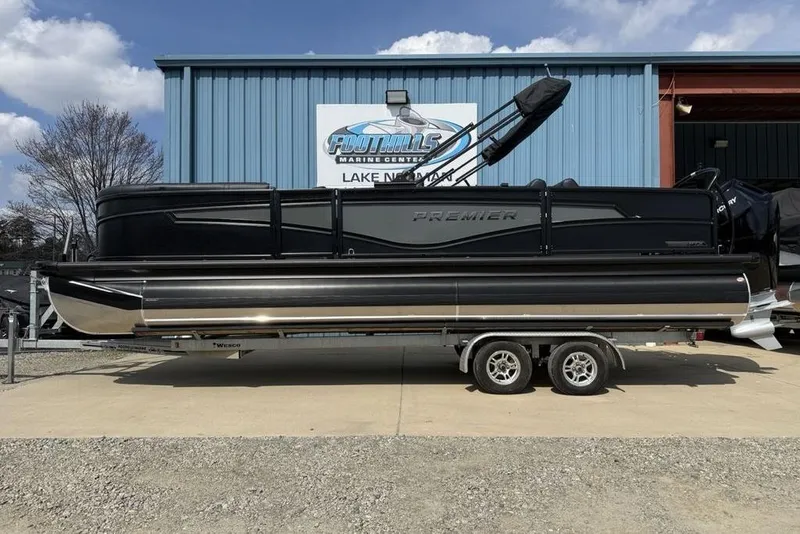 The Image of 2026 Premier 230 Intrigue RF pontoon boat on trailer at marine center. - 2