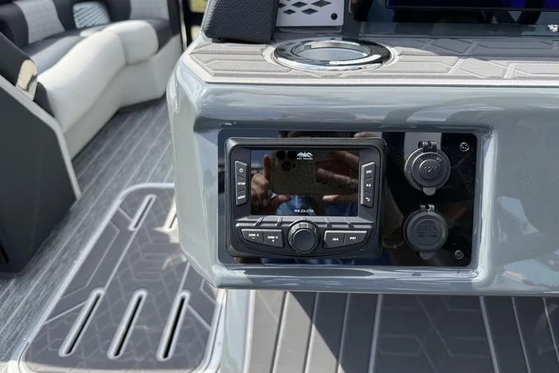 Slide: The Image of Control panel of 2026 Premier 230 Intrigue RF boat with audio system and cup holder. - 20