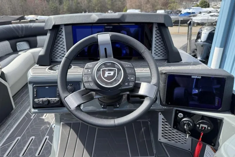 Slide: The Image of 2026 Premier 230 Intrigue RF boat dashboard with steering wheel and digital displays. - 23