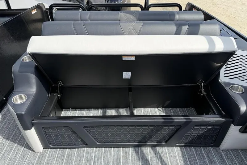 Slide: The Image of Open storage compartment on 2026 Premier 230 Intrigue RF boat with cup holders. - 25