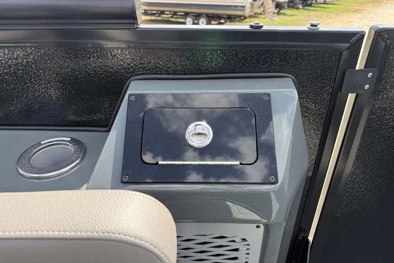 Slide: The Image of 2026 Premier 230 Intrigue RF boat dashboard with storage compartment and cup holder. - 30