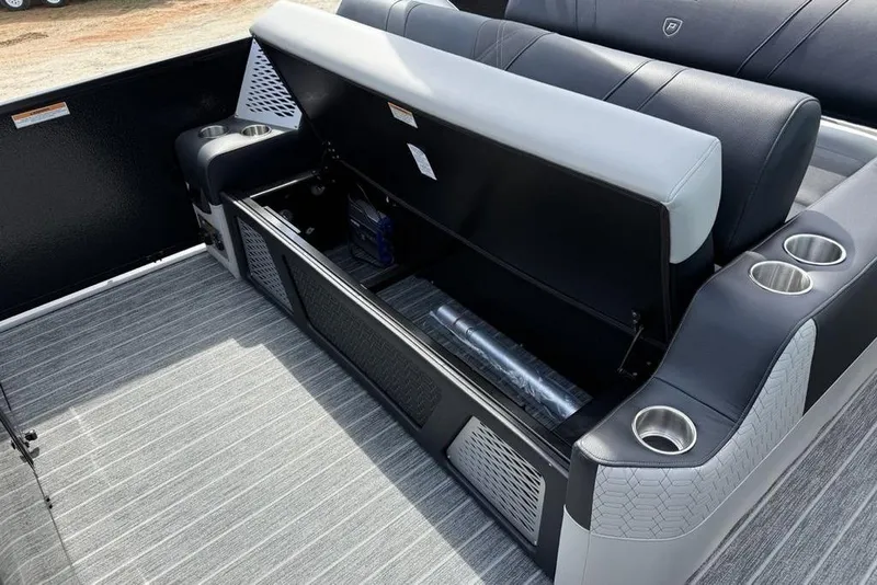 Slide: The Image of 2026 Premier 230 Intrigue RF boat interior with open storage compartment and cup holders. - 35