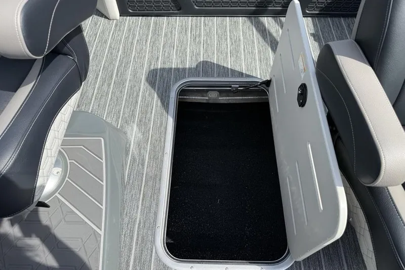 Slide: The Image of Open storage compartment on 2026 Premier 230 Intrigue RF boat with gray seating and flooring. - 36
