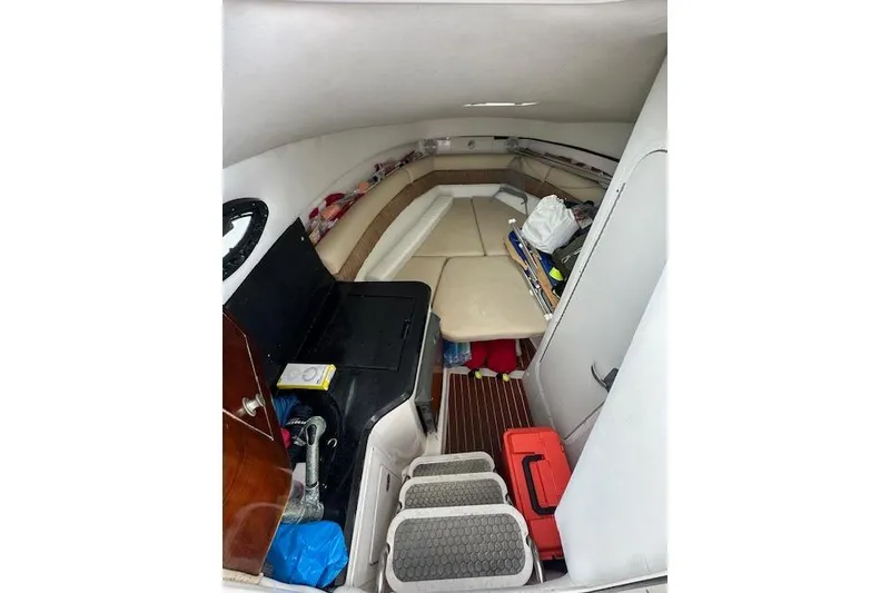 Slide: The Image of Interior cabin of a 2005 Century 2600 Walk-Around boat, featuring seating and storage. - 12