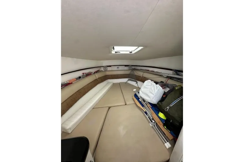 Slide: The Image of Interior cabin of 2005 Century 2600 Walk-Around boat with storage and seating. - 13