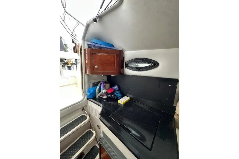 Slide: The Image of Interior of a 2005 Century 2600 Walk-Around boat with storage and countertop. - 14