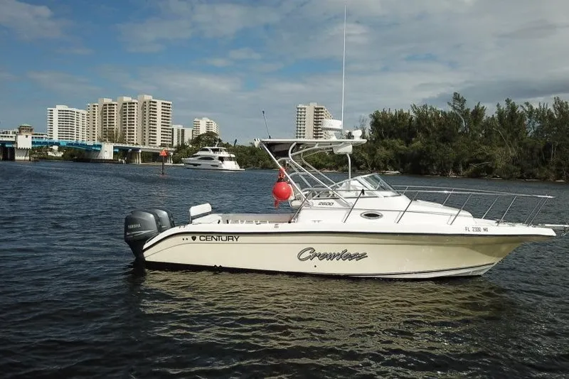 Slide: The Image of 2005 Century 2600 Walk-Around boat on water with cityscape background. - 16