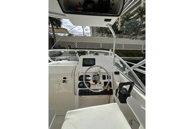 Slide: The Image of 2005 Century 2600 Walk-Around boat cockpit with steering wheel and control panel. - 8
