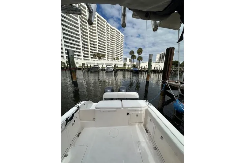 Slide: The Image of 2005 Century 2600 Walk-Around boat docked near waterfront buildings and palm trees. - 9