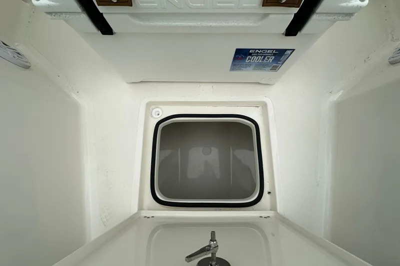 Slide: The Image of Interior view of 2026 Pioneer 220 Bay Sport boat with Engel cooler and storage compartment. - 11