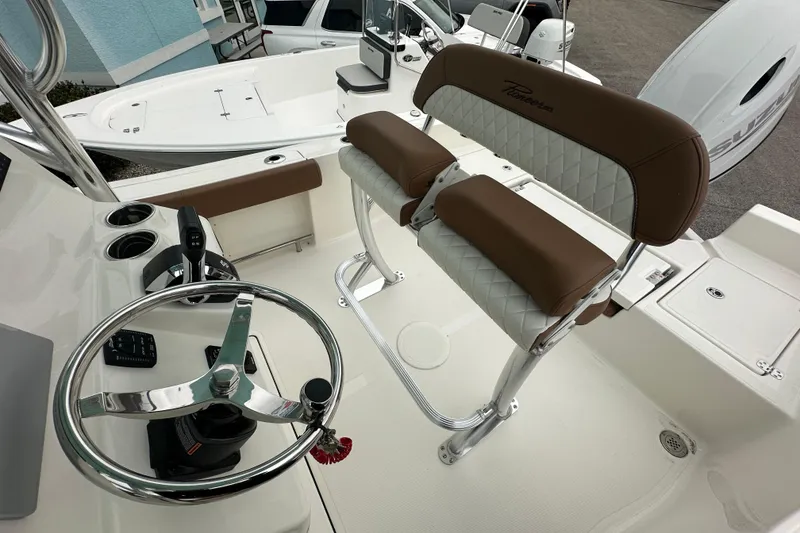 Slide: The Image of 2026 Pioneer 220 Bay Sport boat interior with steering wheel and seating. - 13