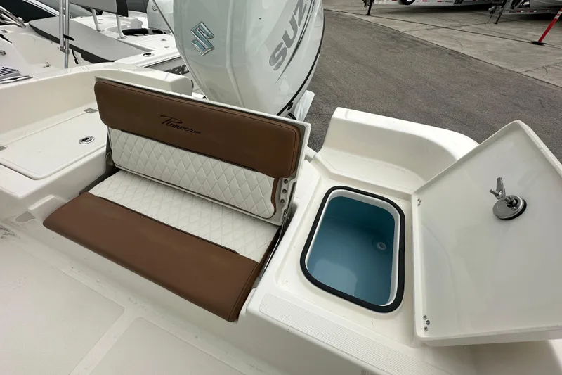 Slide: The Image of 2026 Pioneer 220 Bay Sport boat interior with cushioned seating and storage compartment. - 14