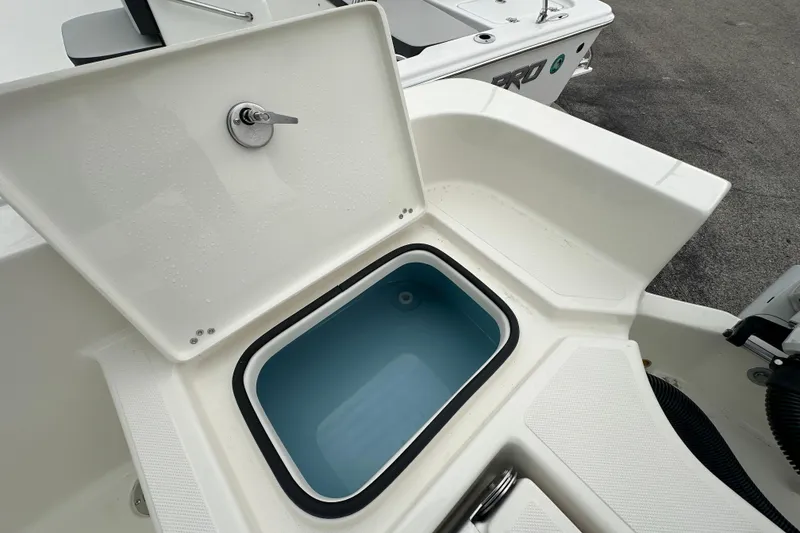 Slide: The Image of Open storage compartment on 2026 Pioneer 220 Bay Sport boat, featuring a water-filled interior. - 15