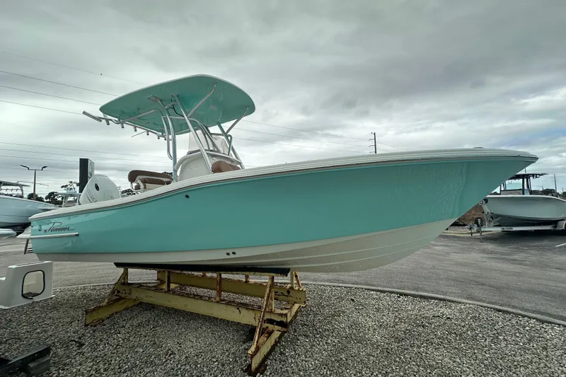 Slide: The Image of 2026 Pioneer 220 Bay Sport boat in light blue on display outdoors. - 4