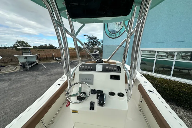 Slide: The Image of 2026 Pioneer 220 Bay Sport boat interior with Garmin navigation system and steering wheel. - 5