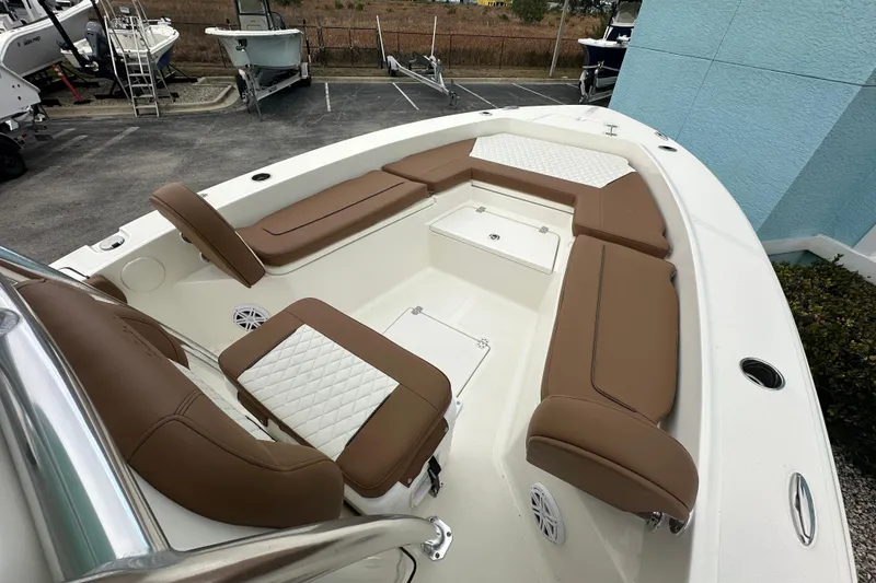 Slide: The Image of 2026 Pioneer 220 Bay Sport boat with brown seating and white accents. - 6