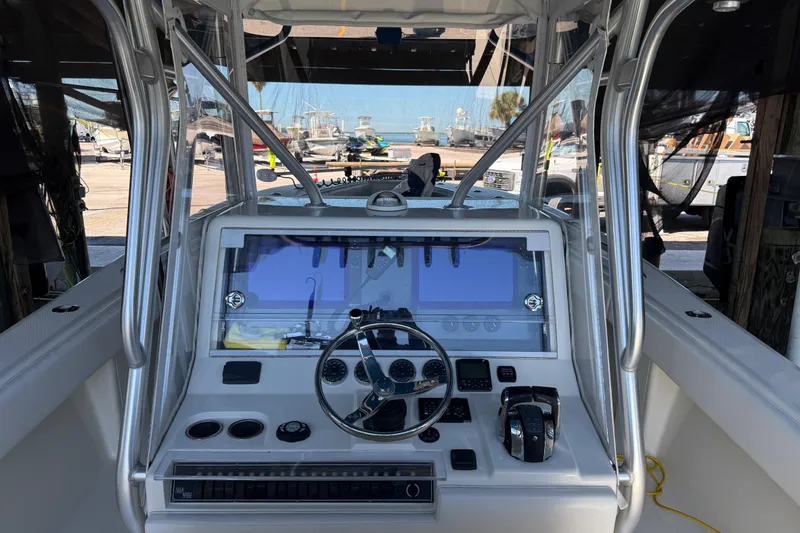 Slide: The Image of 2016 SeaVee 370Z boat cockpit with steering wheel and navigation controls. - 10