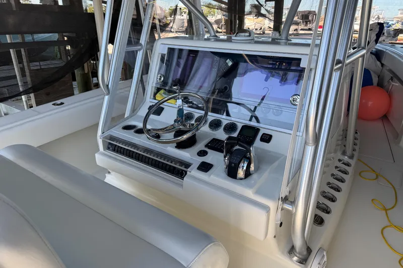 Slide: The Image of 2016 SeaVee 370Z boat console with steering wheel, controls, and navigation screens. - 11
