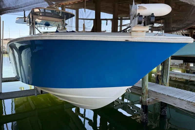 Slide: The Image of 2016 SeaVee 370Z boat in dock, blue hull, partially submerged in water. - 22