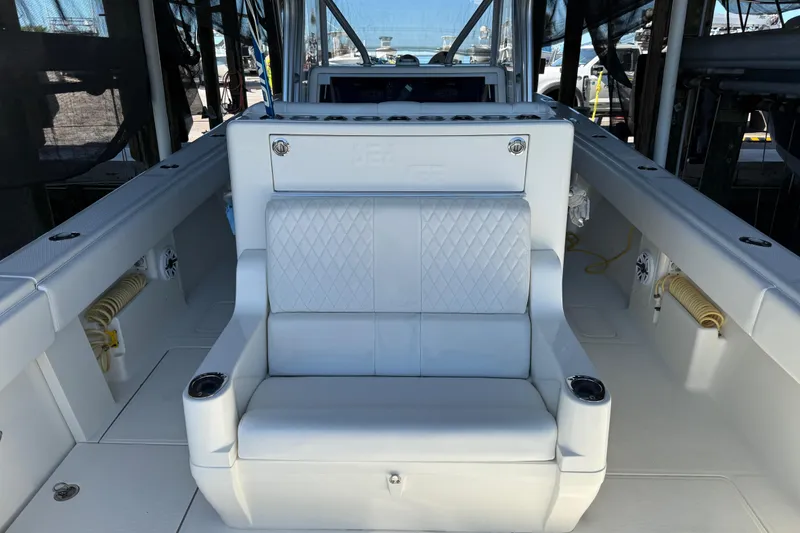 Slide: The Image of 2016 SeaVee 370Z boat interior with white seating and cup holders. - 8