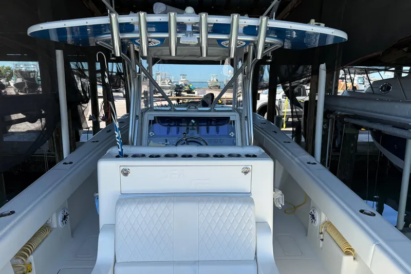 Slide: The Image of 2016 SeaVee 370Z boat interior with helm and seating, docked in a marina. - 9