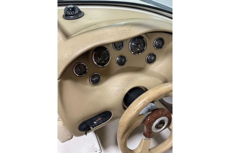 Slide: The Image of Dashboard of a 2000 Sea Ray 210 Bow Rider boat with gauges and compass. - 10