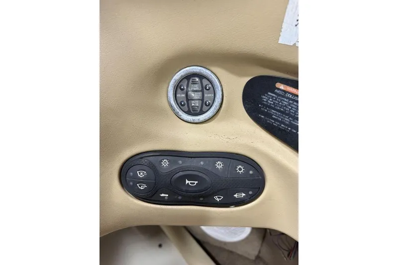 Slide: The Image of Control panel of a 2000 Sea Ray 210 Bow Rider boat with various switches. - 12