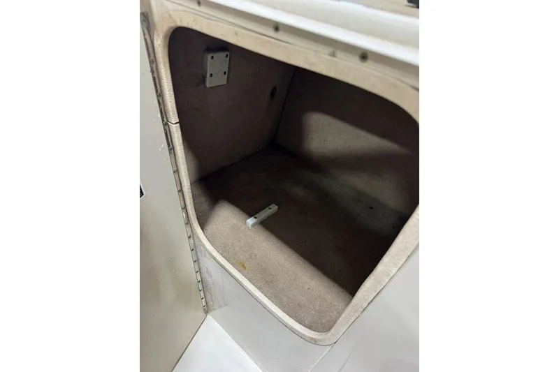 Slide: The Image of Storage compartment inside a 2000 Sea Ray 210 Bow Rider boat. - 13