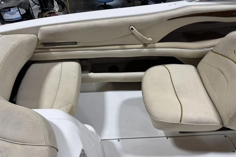 Slide: The Image of Interior seating of a 2000 Sea Ray 210 Bow Rider boat, featuring cream upholstery. - 15