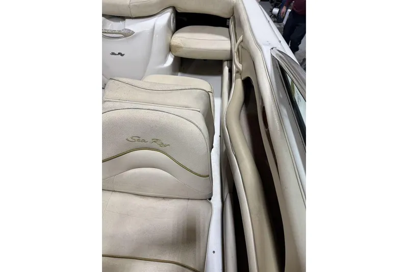 Slide: The Image of Interior of 2000 Sea Ray 210 Bow Rider with beige seating and logo. - 17