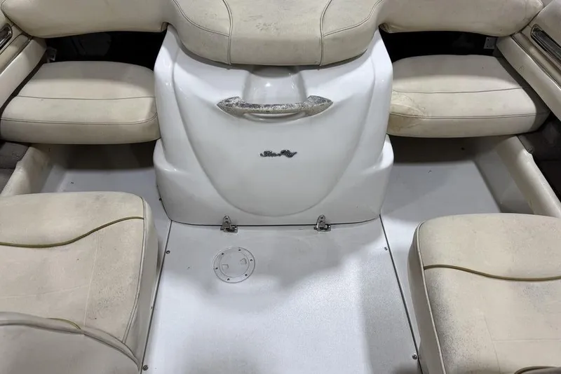 Slide: The Image of 2000 Sea Ray 210 Bow Rider interior with beige seating and white flooring. - 18