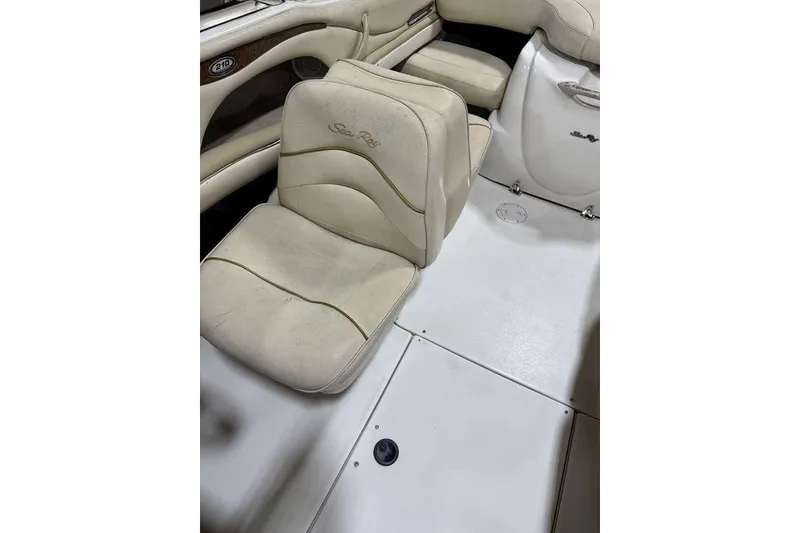 Slide: The Image of 2000 Sea Ray 210 Bow Rider interior with beige seating and sleek design. - 19