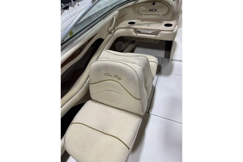 Slide: The Image of 2000 Sea Ray 210 Bow Rider interior with beige seating and dashboard details. - 20