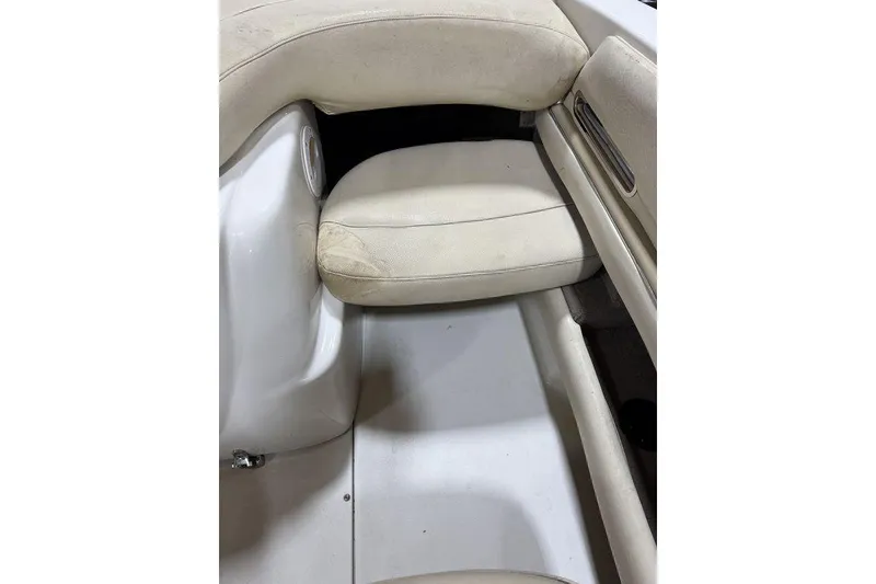 Slide: The Image of Interior seating of a 2000 Sea Ray 210 Bow Rider boat, featuring white upholstery. - 21