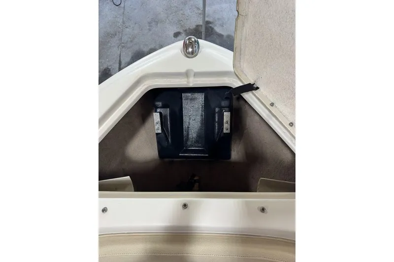 Slide: The Image of 2000 Sea Ray 210 Bow Rider storage compartment with black battery box. - 3