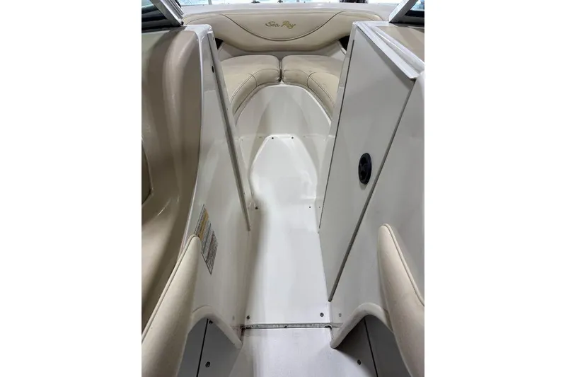 Slide: The Image of Interior view of 2000 Sea Ray 210 Bow Rider boat with beige seating. - 4