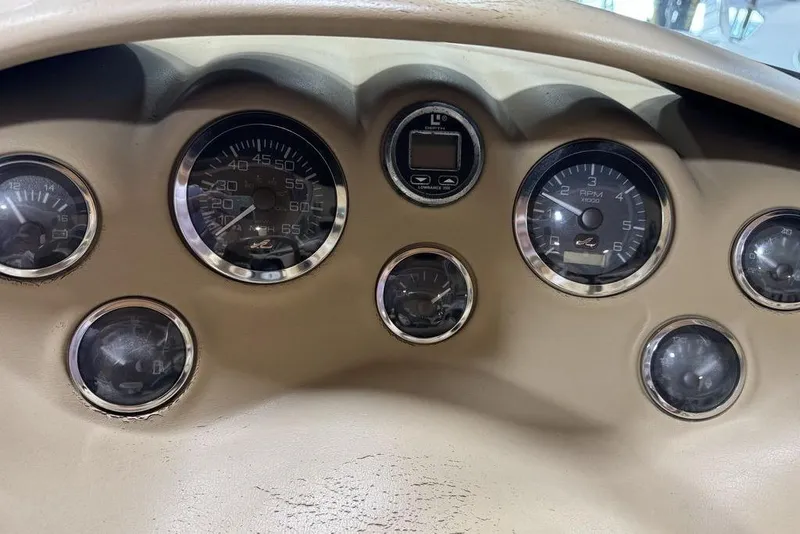 Slide: The Image of Dashboard of a 2000 Sea Ray 210 Bow Rider boat with multiple gauges. - 8