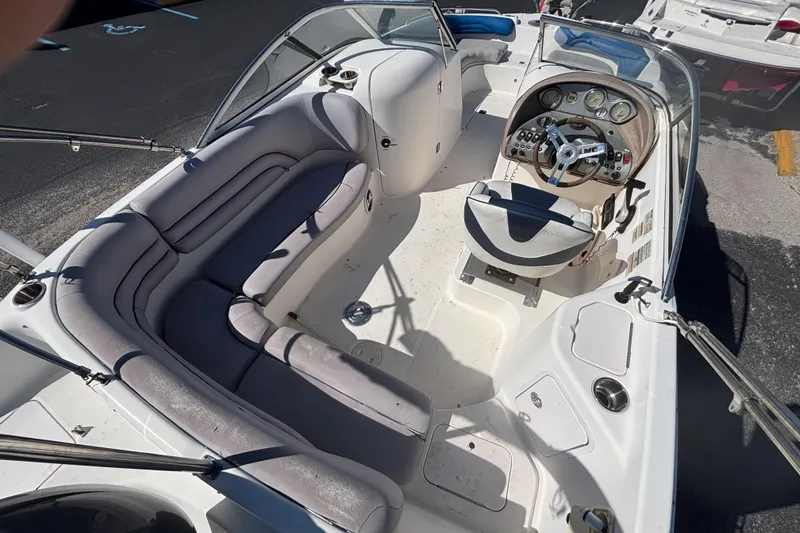 Slide: The Image of 2006 Hurricane SunDeck 217 OB boat interior with seating and steering console. - 10